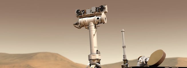 A Mars rover on a rocky Martian surface, with hills and rocks in the background.